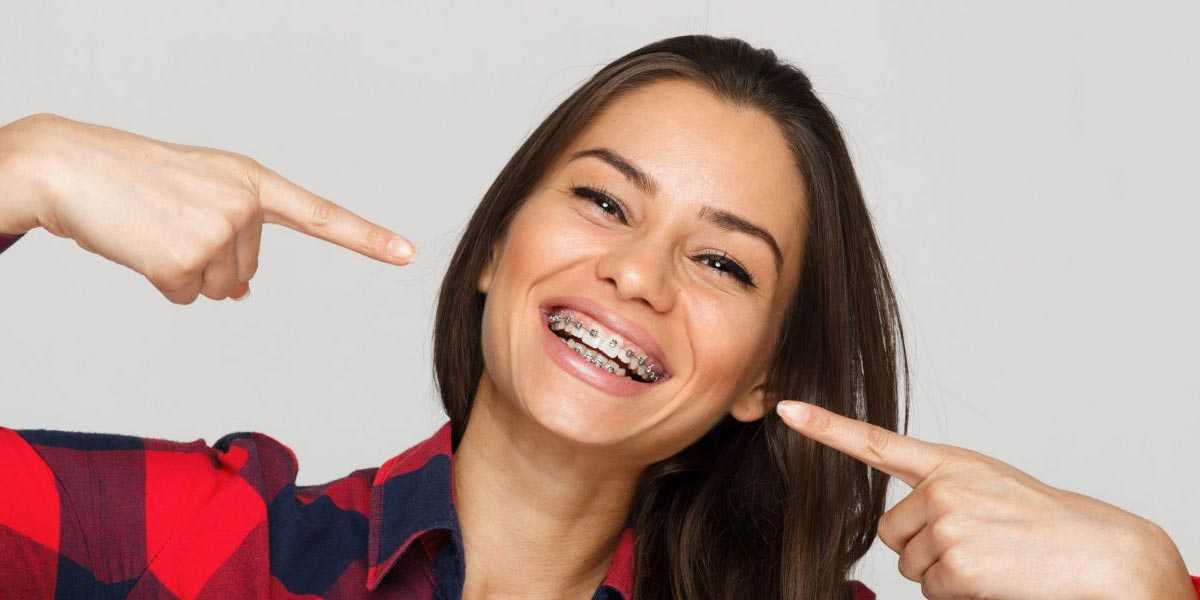 Woman Pointing At Her Braces